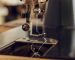 Close-up image of the needle of a vintage sewing machine.